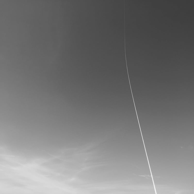 A kite high up in the deep blue sky.