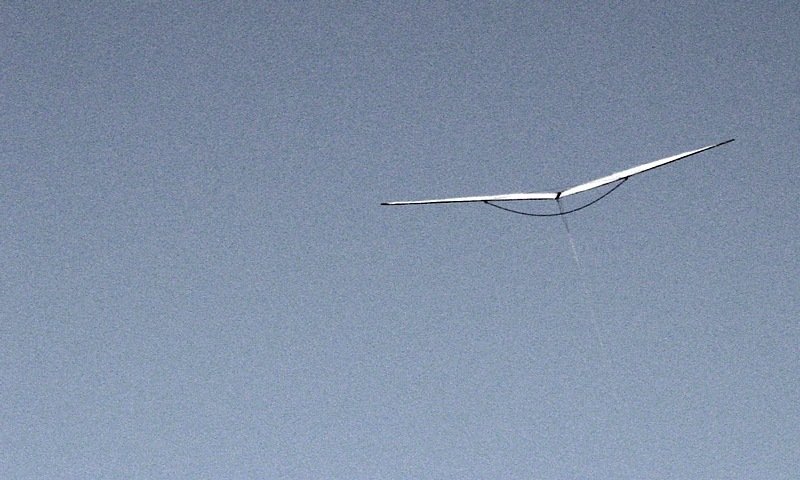 Frontal silhouette of the zerowind kite, floating.