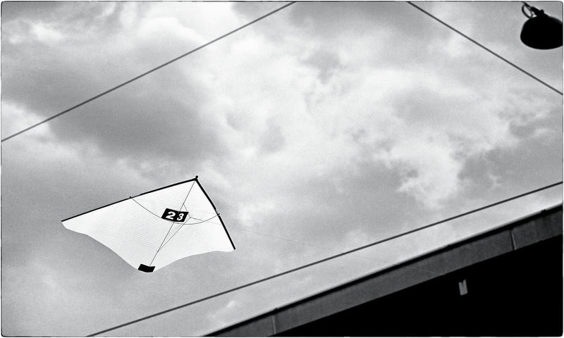 Kite in front of urban wires before the storm.