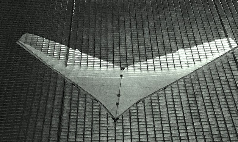 Kite on the underground parking with neon light from below.