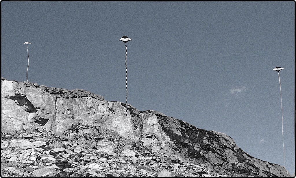 3 lightwind kites above the mountains in normal wind.