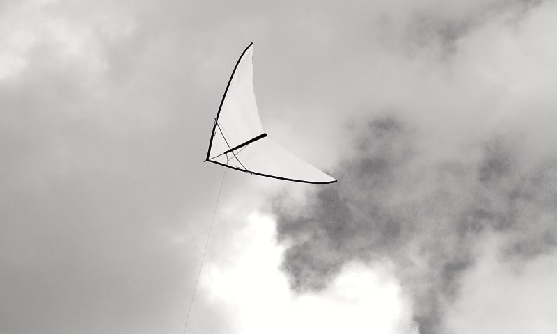 The white zero wind kite is gliding upwards.